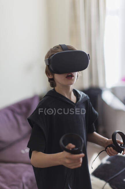 Boy playing video game with VRS goggles — Stock Photo