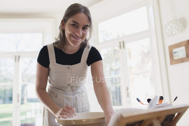 Portrait smiling teenage girl baking in kitchen — Stock Photo