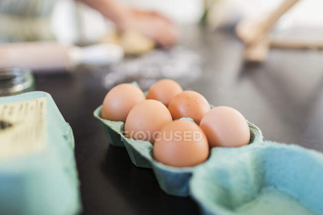 Close up fresh brown eggs in carton — Stock Photo