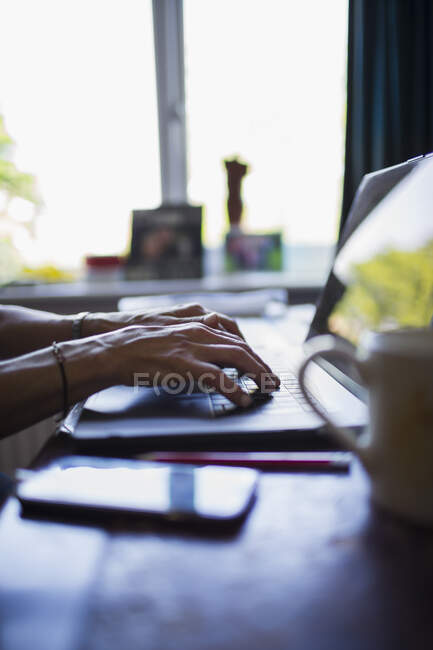 Hands of woman typing on laptop working from home — Stock Photo