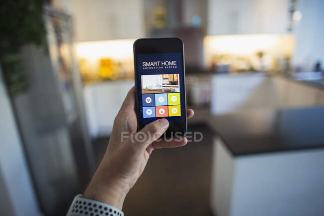 POV Man using home automation on smart phone screen — Stock Photo