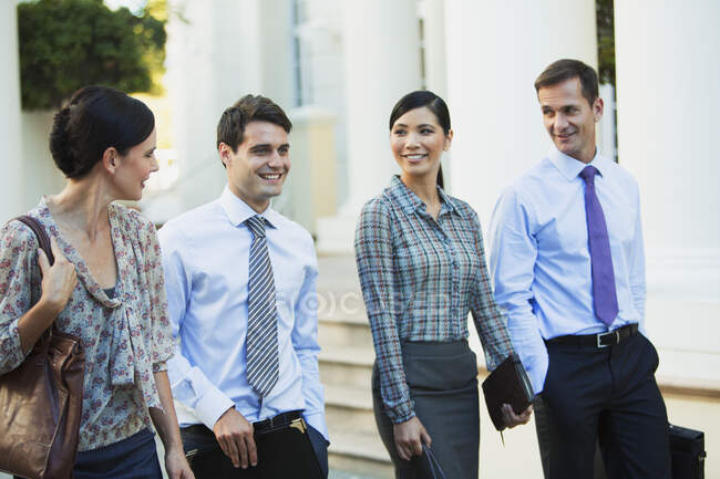 Business people walking outdoors — Stock Photo