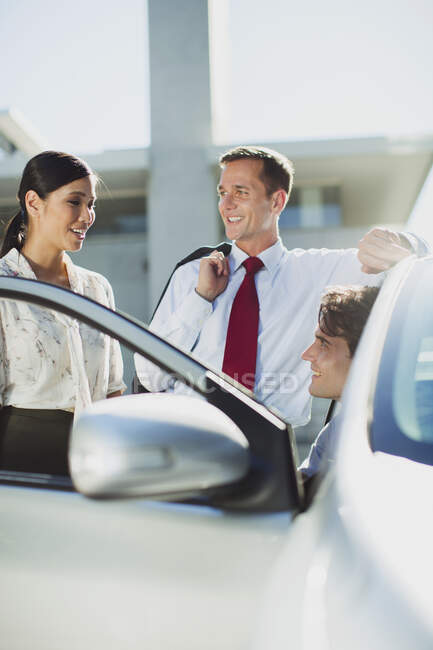 Business people talking at car — Stock Photo