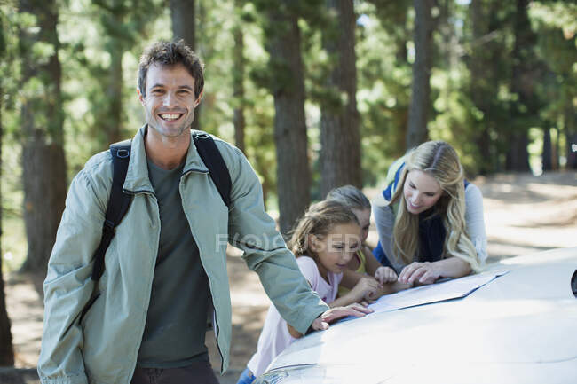 Smiling man with family in woods — Stock Photo