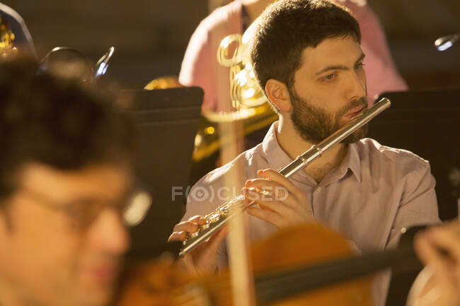 Flutist performing in orchestra — Stock Photo
