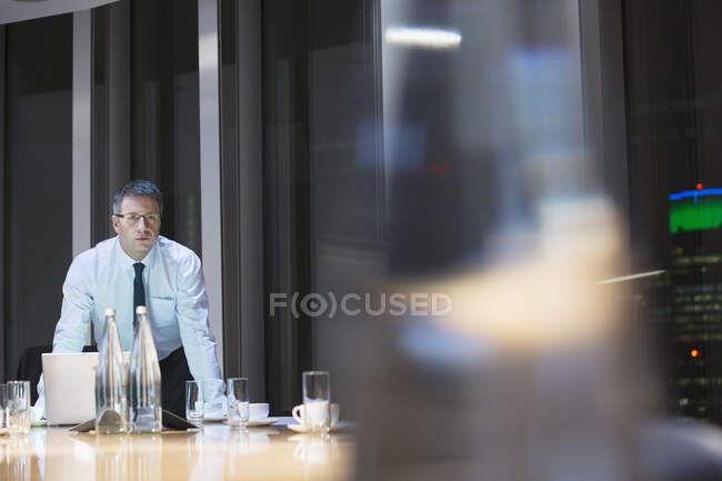 Businessman in conference room at night — Stock Photo
