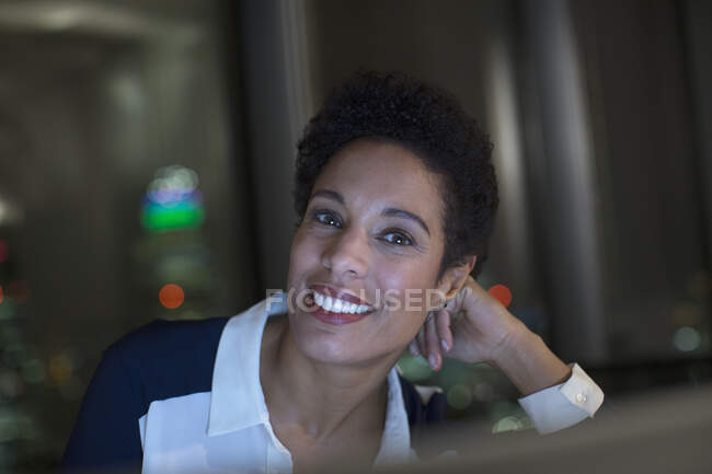 Portrait of confident businesswoman in office at night — Stock Photo