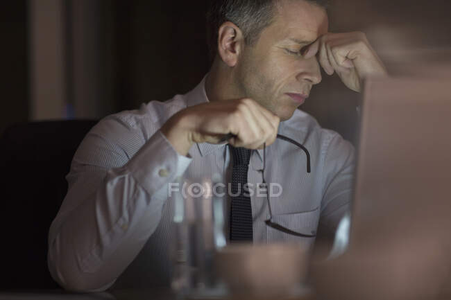 Tired businessman in office at night — Stock Photo