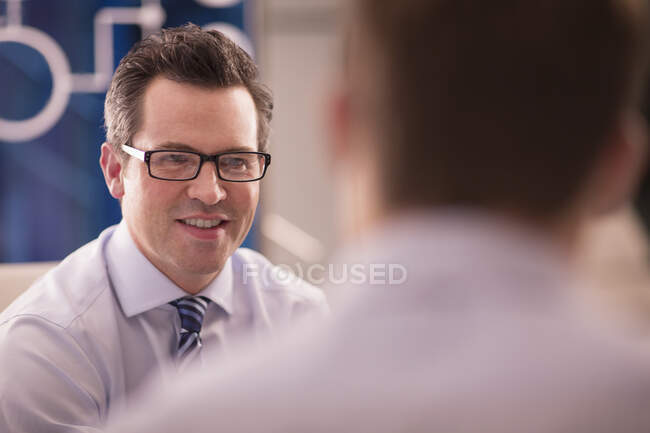 Businessmen talking in conference room — Stock Photo