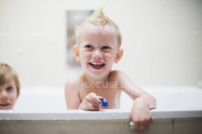 Two boys, brothers having bath in white bathroom — Stock Photo