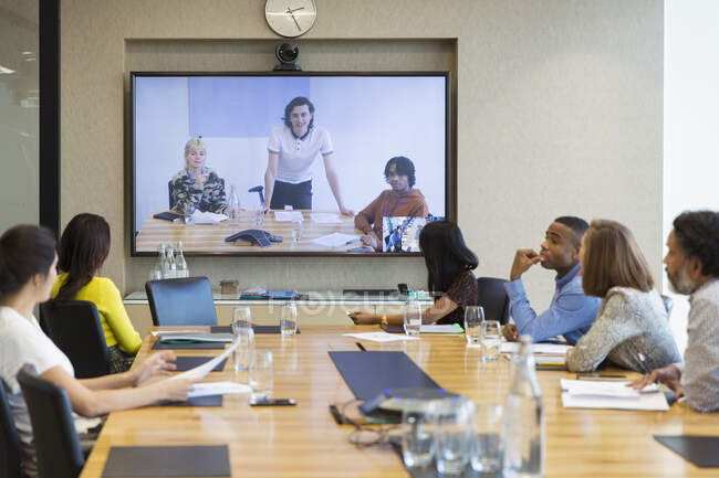 Business people video conferencing in conference room — Stock Photo