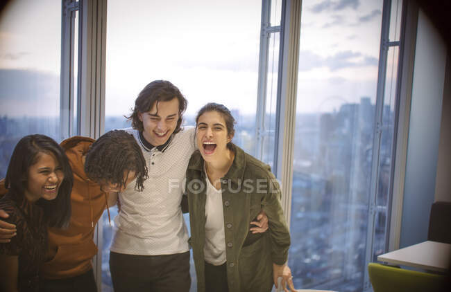 Щасливі молоді ділові люди сміються в високогірному офісі — стокове фото