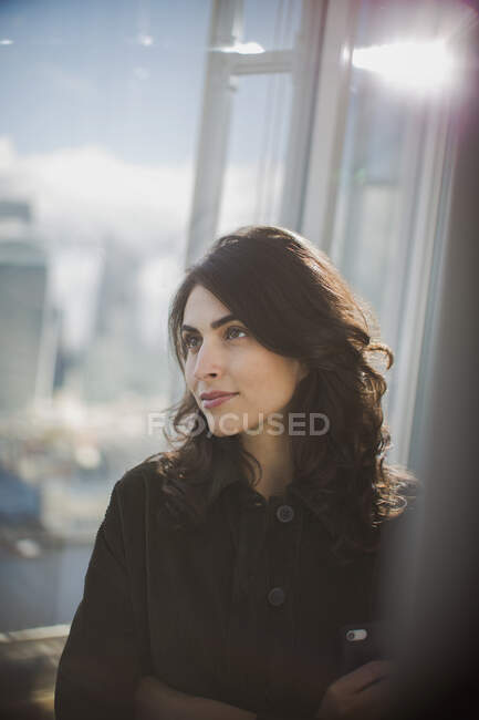 Thoughtful businesswoman at office window — Stock Photo