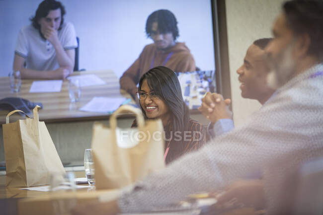 Business people with takeout lunch video conferencing in meeting — Stock Photo
