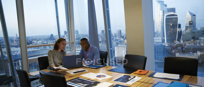 Business people working at laptop in highrise conference room meeting — Stock Photo