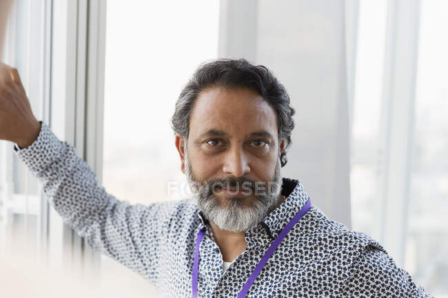 Portrait confident businessman at window — Stock Photo