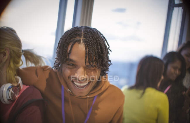 Portrait laughing young man with friends — Stock Photo