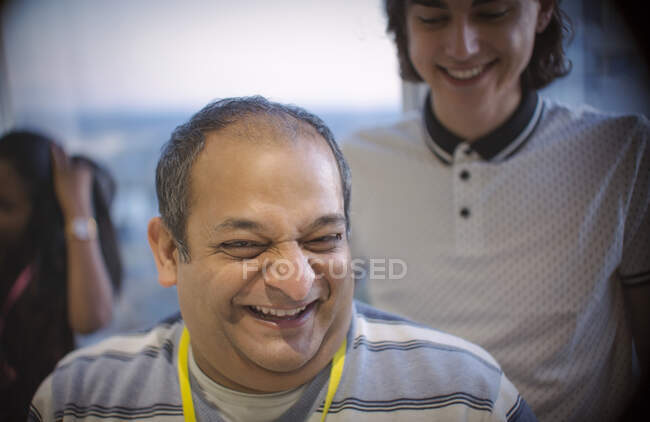 Laughing businessman in office — Stock Photo