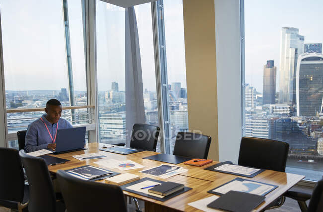 Uomo d'affari che lavora al computer portatile in sala conferenze grattacielo, Londra, Regno Unito — Foto stock