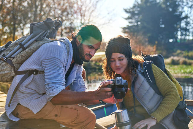 Young hiking couple using digital camera — Stock Photo
