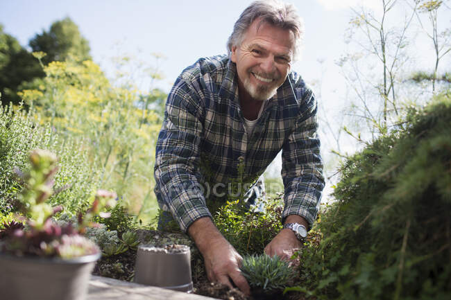 Portrait happy senior man gardening — Stock Photo