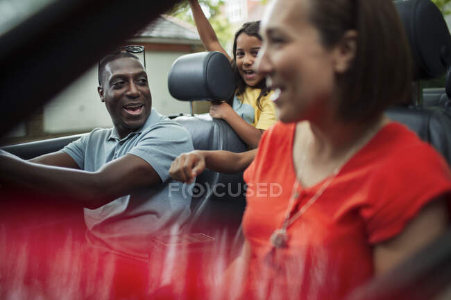 Happy family riding in convertible — Stock Photo