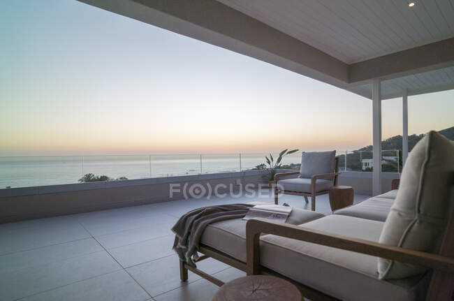 Maison de luxe vitrine patio avec vue panoramique sur l'océan au coucher du soleil — Photo de stock