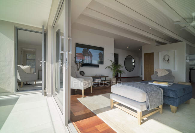 Sunny home showcase living room open to patio — Stock Photo