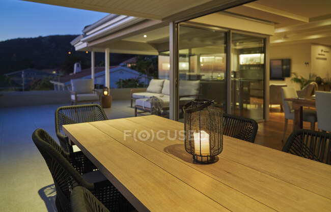 Lanterna con candela sul tavolo da pranzo con patio vetrina di lusso — Foto stock