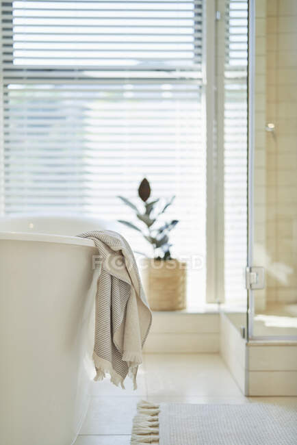 Toalha pendurada sobre banheira de imersão em casa de luxo vitrine banheiro — Fotografia de Stock
