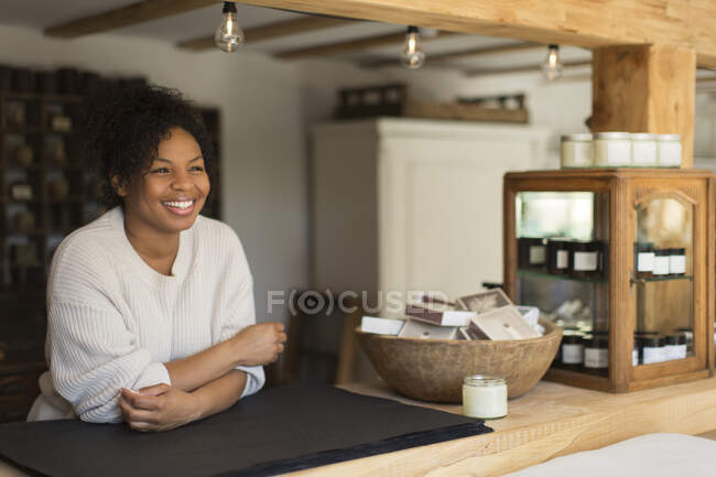Portrait happy confident female shop owner at counter — Stock Photo