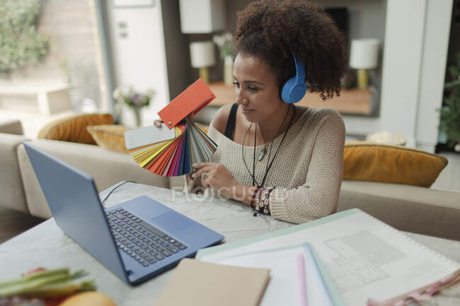 Female interior designer video conferencing from laptop at home — Stock Photo