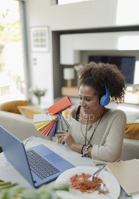 Designer with color swatch video conferencing at laptop — Stock Photo