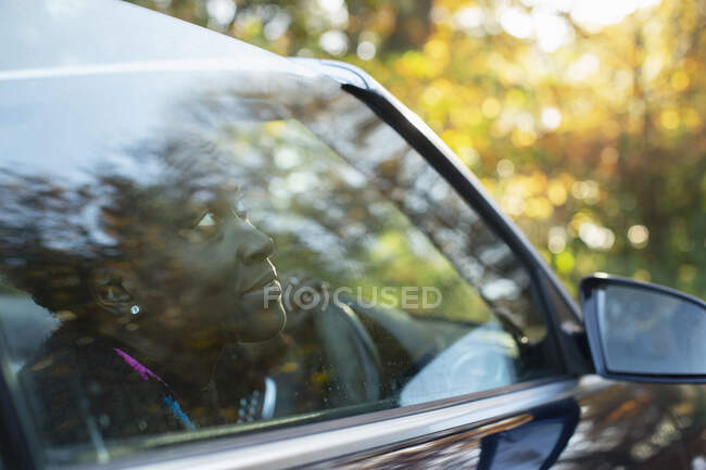 Curious woman looking out convertible window — Stock Photo