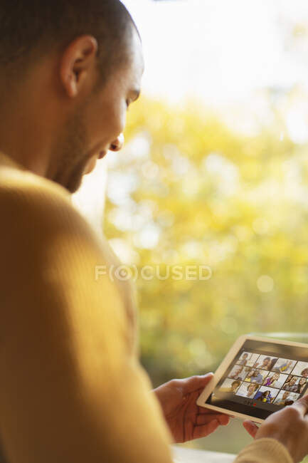 Man video chatting with friends on digital tablet screen — Stock Photo