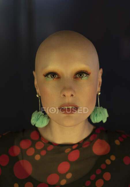 Close up portrait fashionable woman with shaved head and earrings — Stock Photo
