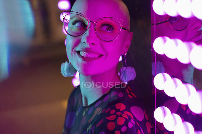Close up portrait beautiful woman with shaved-head, head by neon light — Stock Photo