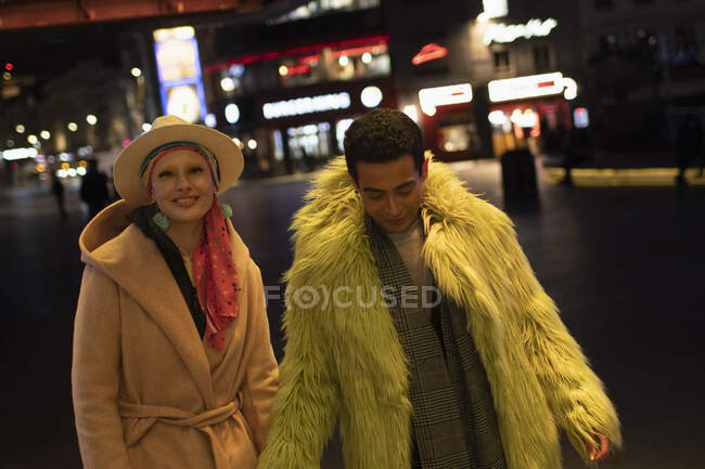 Portrait fashionable couple on city street at night — Stock Photo