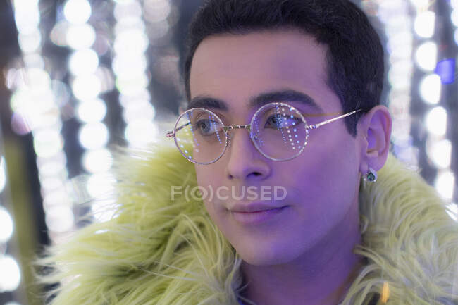 Close up portrait young man in feather boa and eyeglasses — Stock Photo