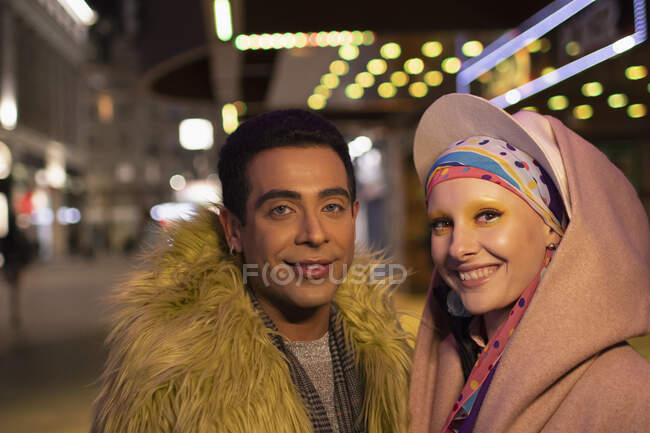 Portrait stylish happy couple in city at night — Stock Photo