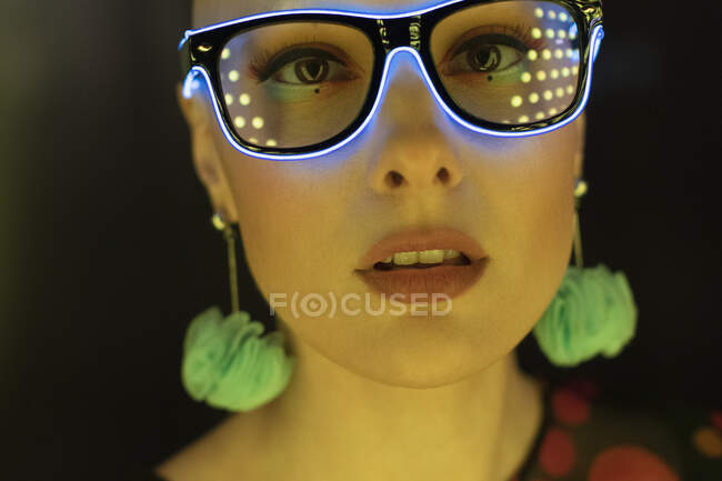 Close up portrait beautiful stylish woman in neon glasses — Stock Photo