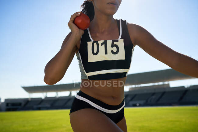Close up female track and field athlete throwing shot put — Stock Photo