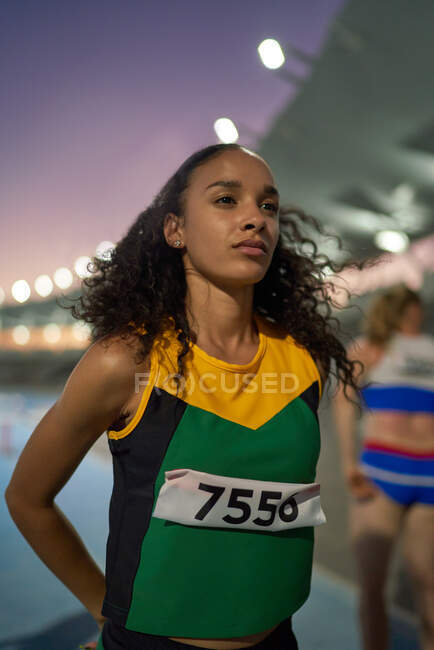 Determined track and field athlete preparing for competition — Stock Photo