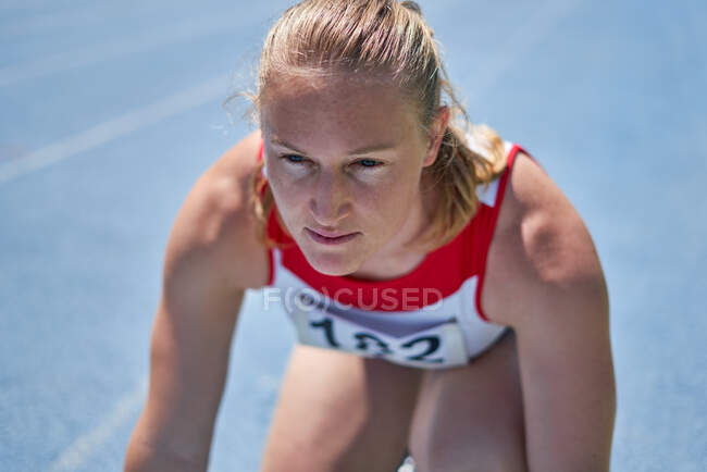 Close up focused female track and field athlete ready for competition — Stock Photo