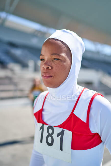 Portrait confident female track and field athlete in hijab — Stock Photo