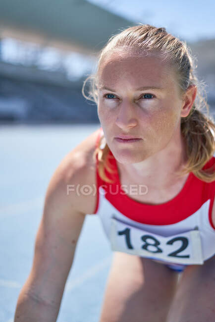Close up determined female track and field athlete — Stock Photo