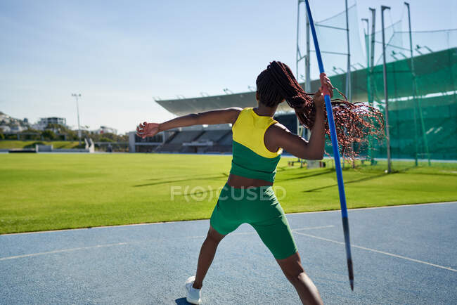 Feminino faixa e campo atleta jogando dardo — Fotografia de Stock