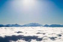 Mountain range in thick layer of clouds — Stock Photo