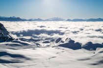 Aerial view of cloud covered mountains and ski resort — Stock Photo