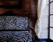 Morocco, Marrakesh, Marrakech hotel. Sofa and curtain by window — Stock Photo